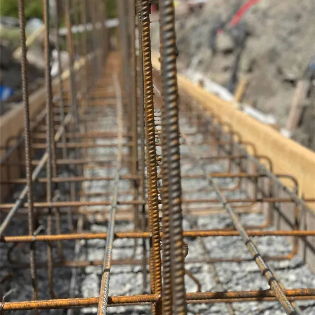 Armeringsjern montert i forskaling for støping av ny betongmur med høy bæreevne.
